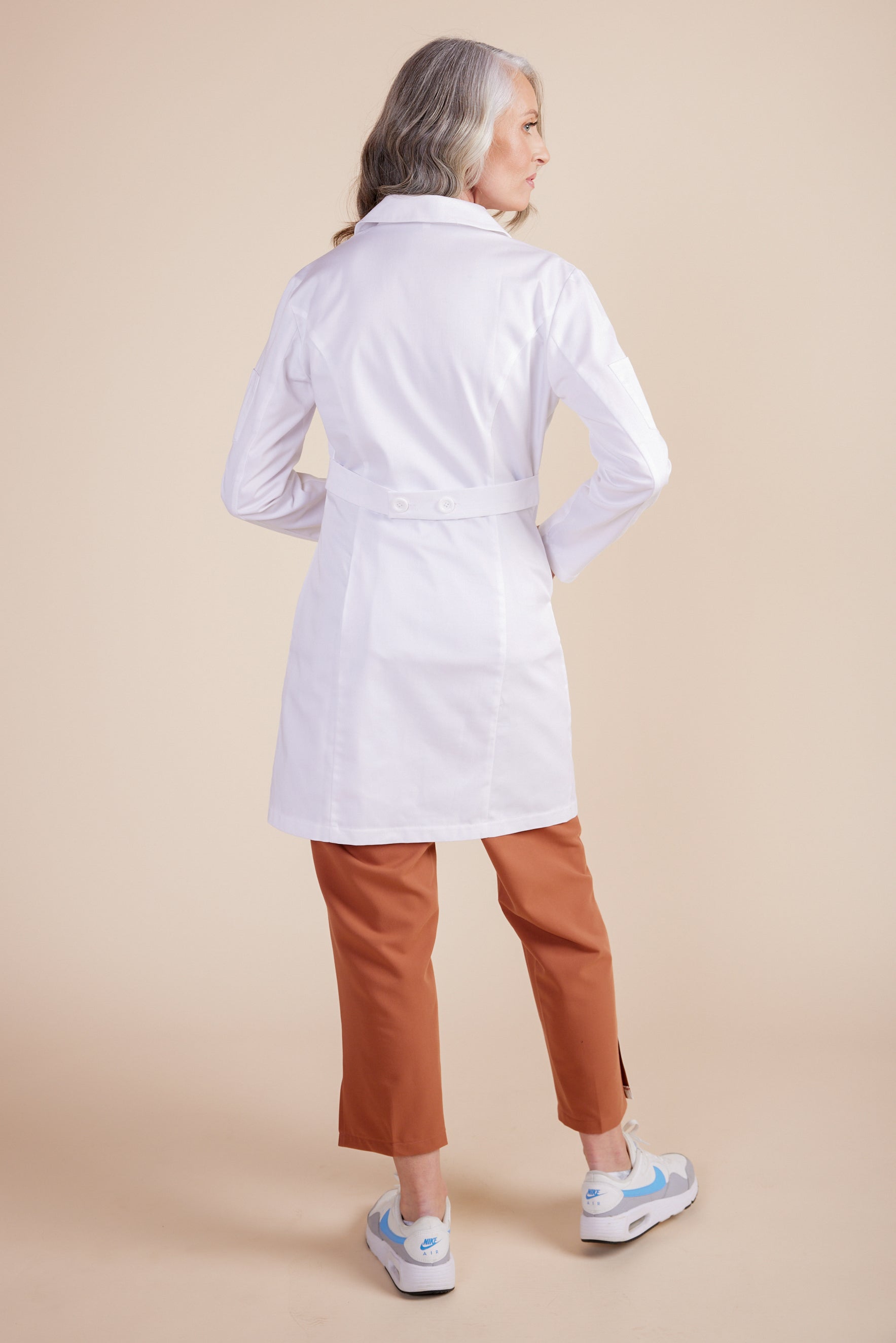Rebecca Lab Coat in White by DUES – luxury lab coat sewn in the USA, featuring a tailored silhouette, double-button front closure, utility sleeve pocket, and spacious front patch pockets for elevated everyday function.