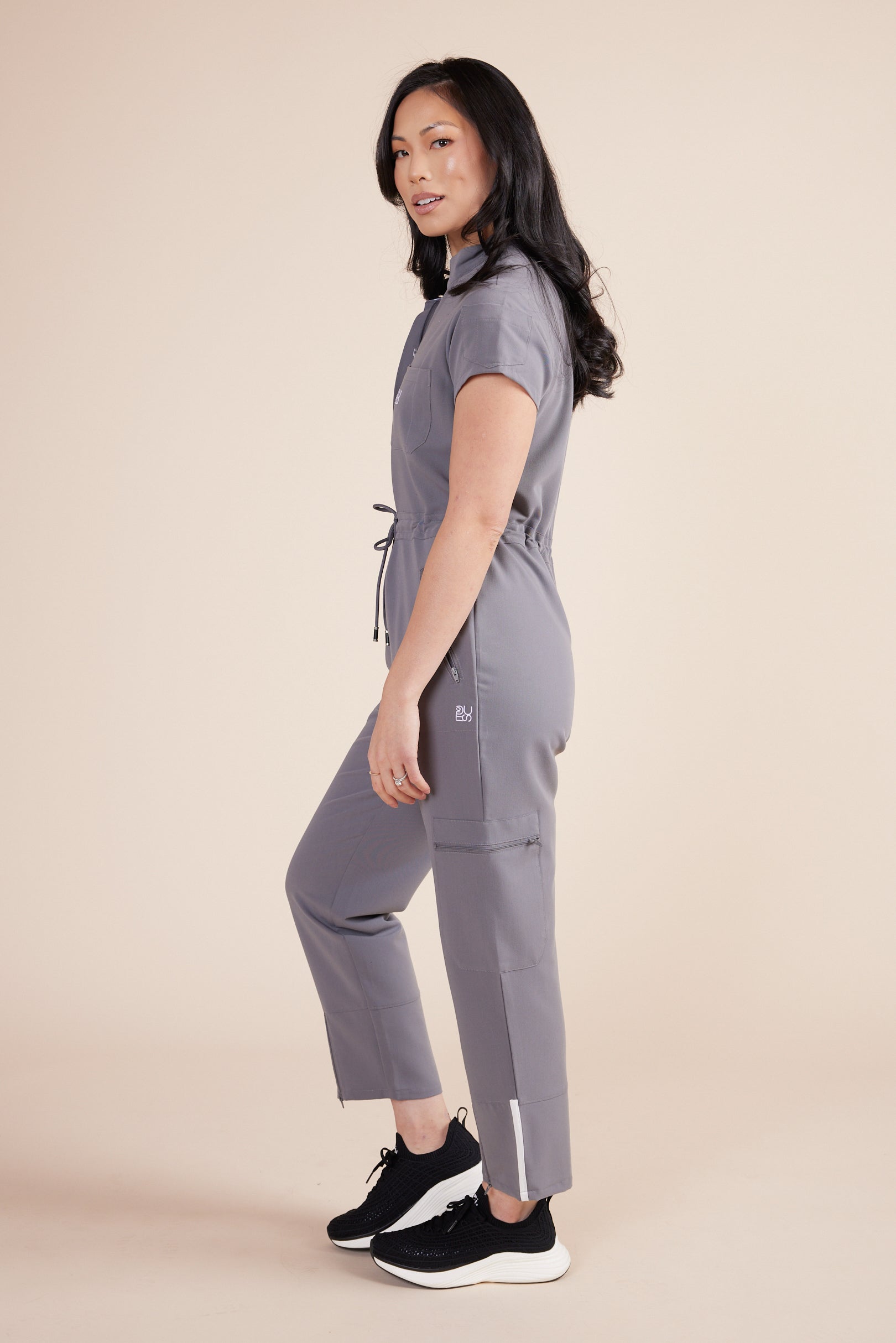 Ebony Scrub Jumpsuit in Gray by DUES – luxury scrub jumpsuit sewn in the USA, offering a polished one-piece design with breathable, high-performance fabric for ultimate comfort.