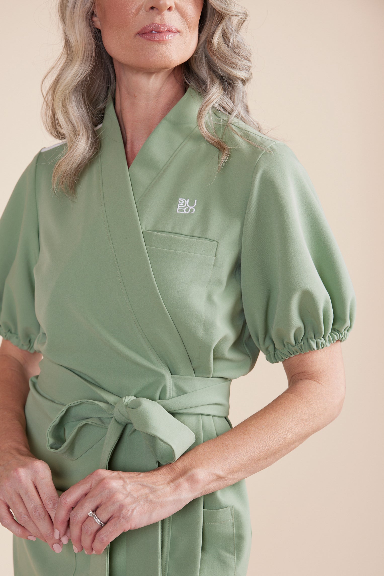 DUES – luxury scrub dress sewn in the USA, featuring a flattering silhouette, breathable stretch fabric, and functional design details for comfort and mobility during long shifts.