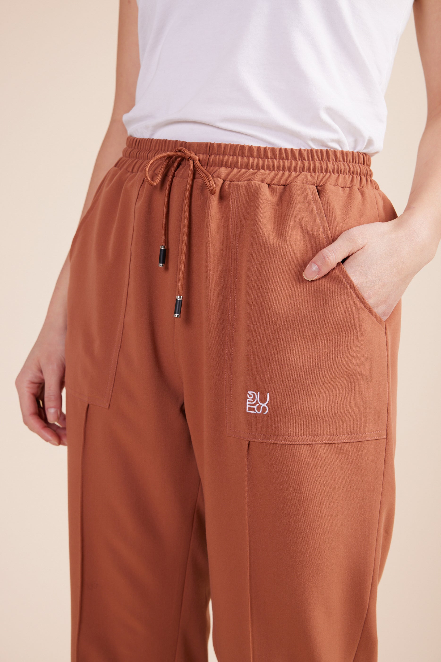 Lynn Joggers in Terracotta by DUES – luxury scrub joggers sewn in the USA, designed for healthcare professionals seeking comfort, durability, and a polished athletic-inspired silhouette.