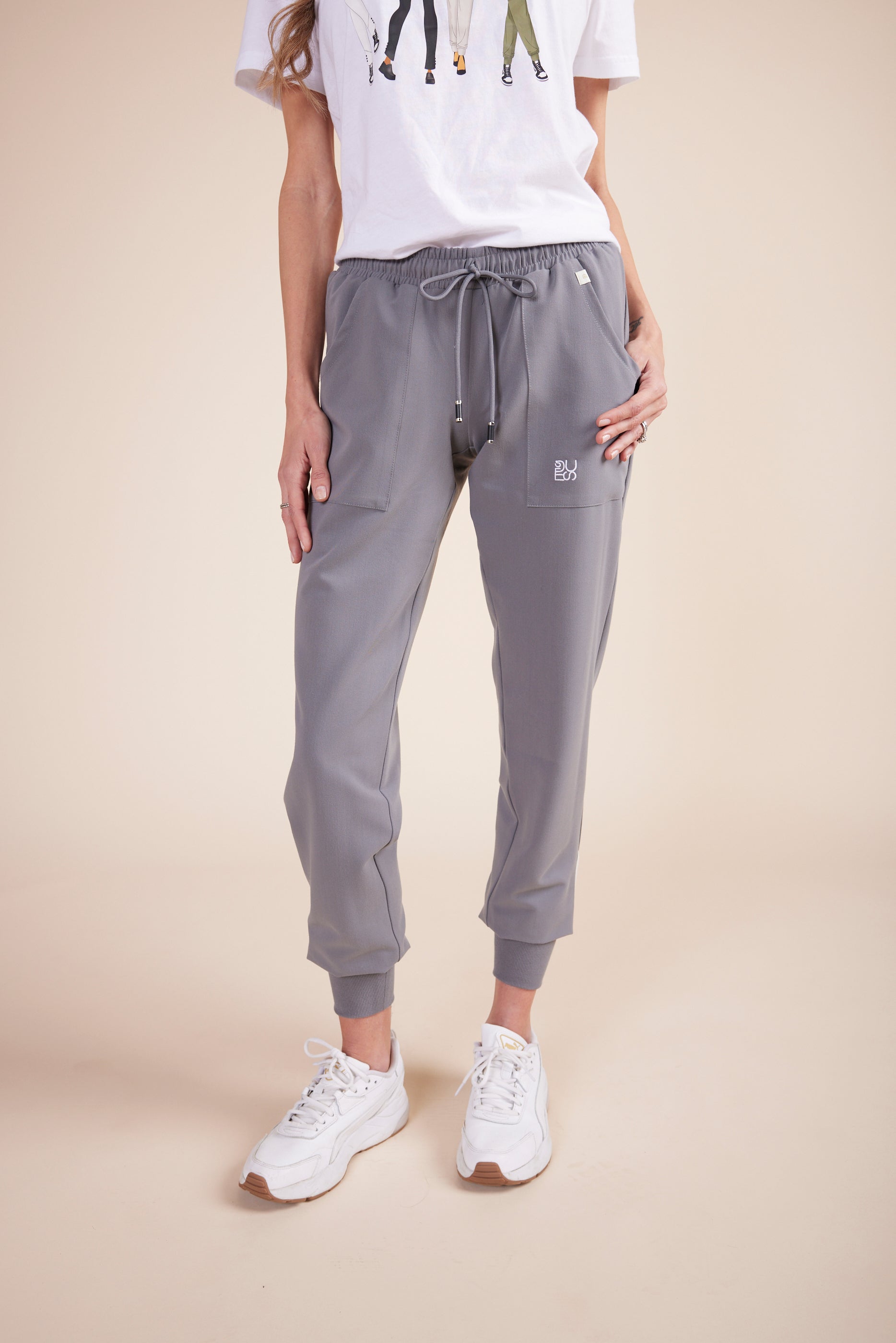 Mache Joggers in Gray by DUES – luxury scrub joggers sewn in the USA, crafted with flexible fabric, tapered legs, and multiple pockets for mobility and convenience.