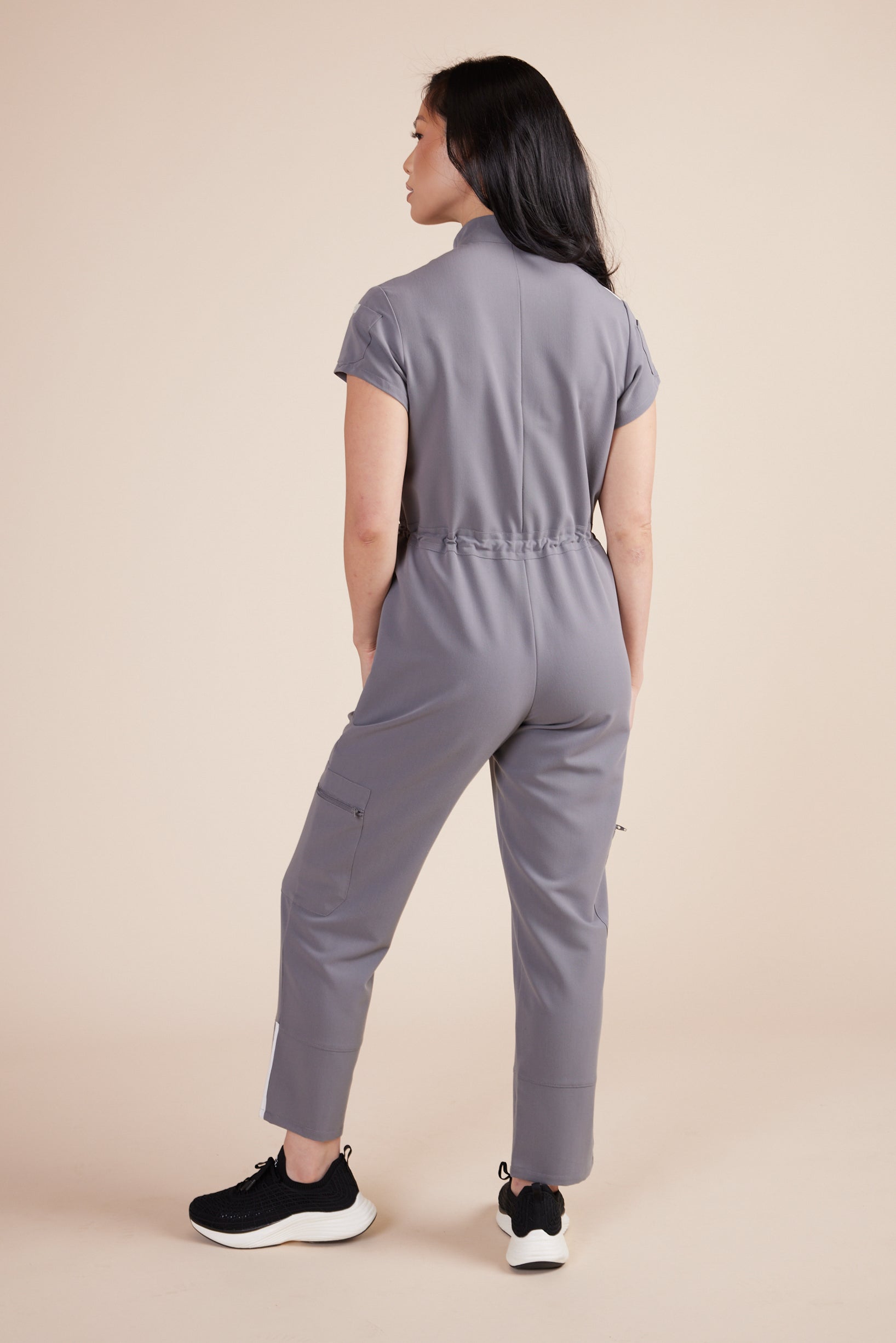 Ebony Scrub Jumpsuit in Gray by DUES – luxury scrub jumpsuit sewn in the USA, offering a polished one-piece design with breathable, high-performance fabric for ultimate comfort.