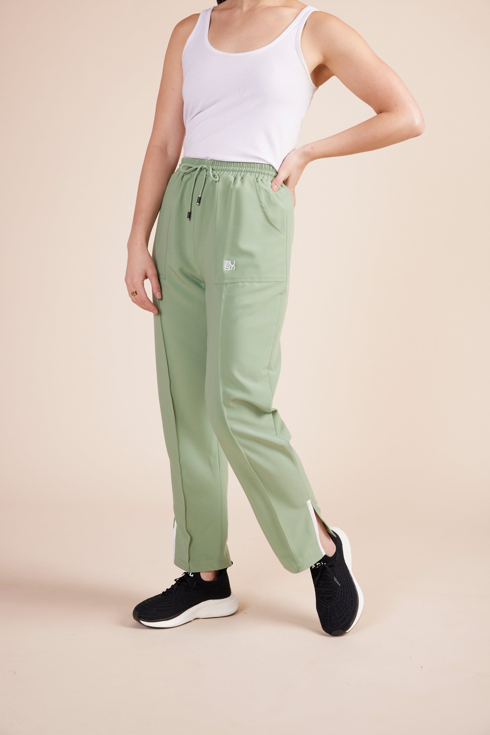 Lynn Joggers in Green Tea by DUES – luxury scrub joggers sewn in the USA, offering a flattering modern fit with breathable fabric and functional detailing for all-day movement.
